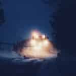 vehicle on snow covered road at nighttime